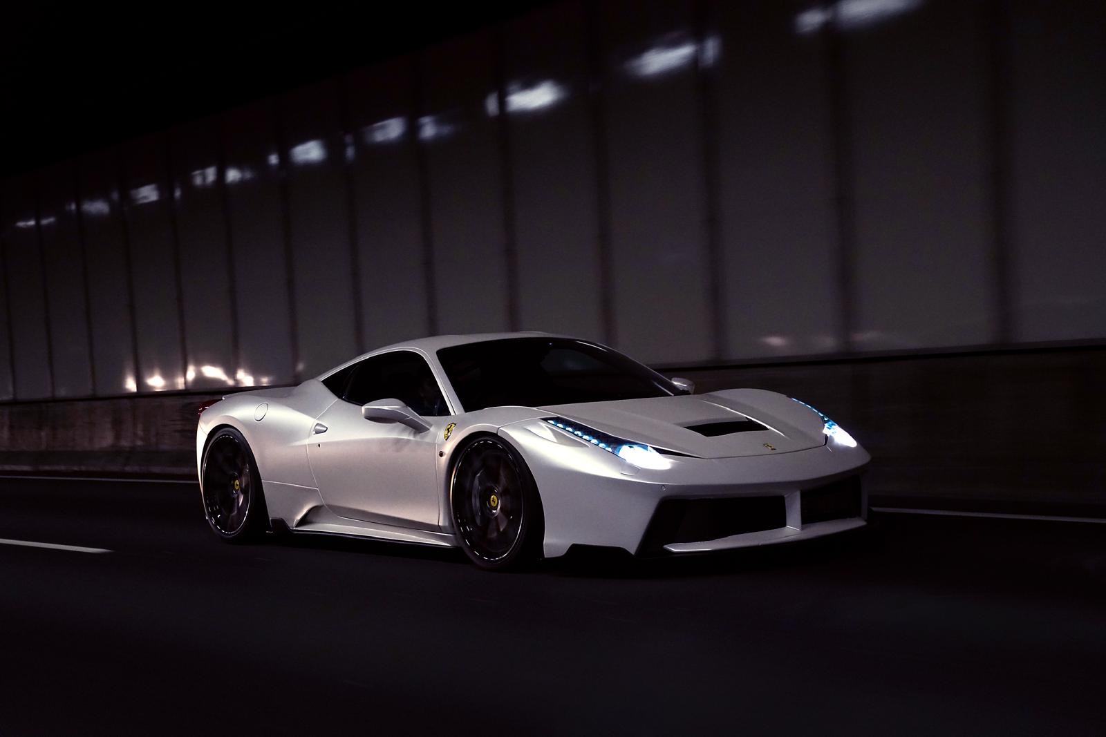 White Ferrari driving through a tunnel at night