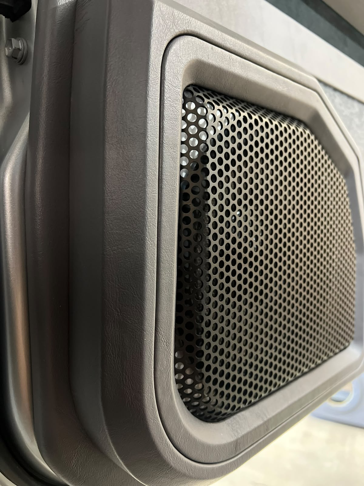 Custom speaker grille built into a Mercedes G-Class door card