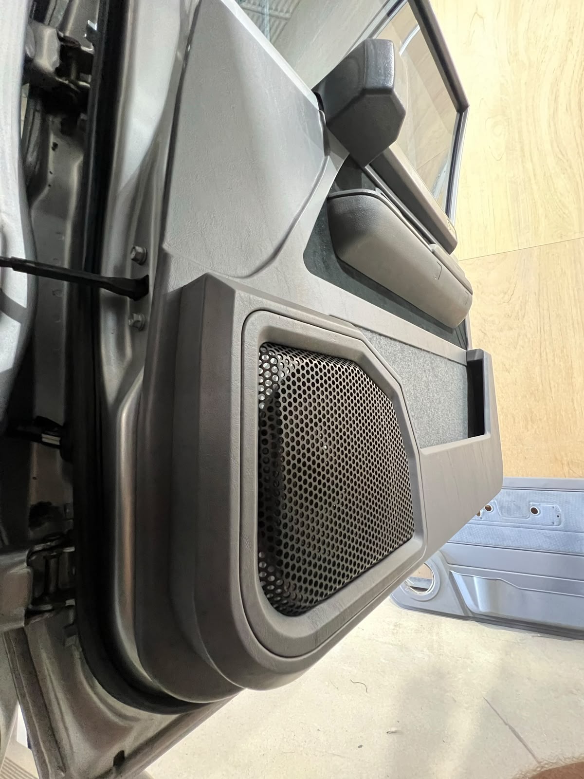 Custom door card with fabricated speaker pod and mesh grille